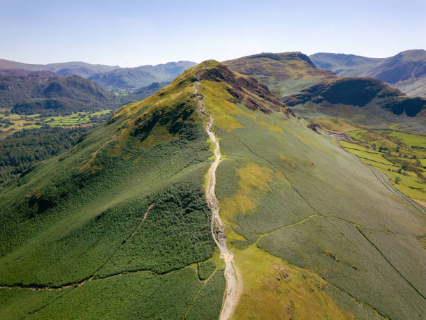 A hiker on the ridge of Catbells overlooking Derwentwater.