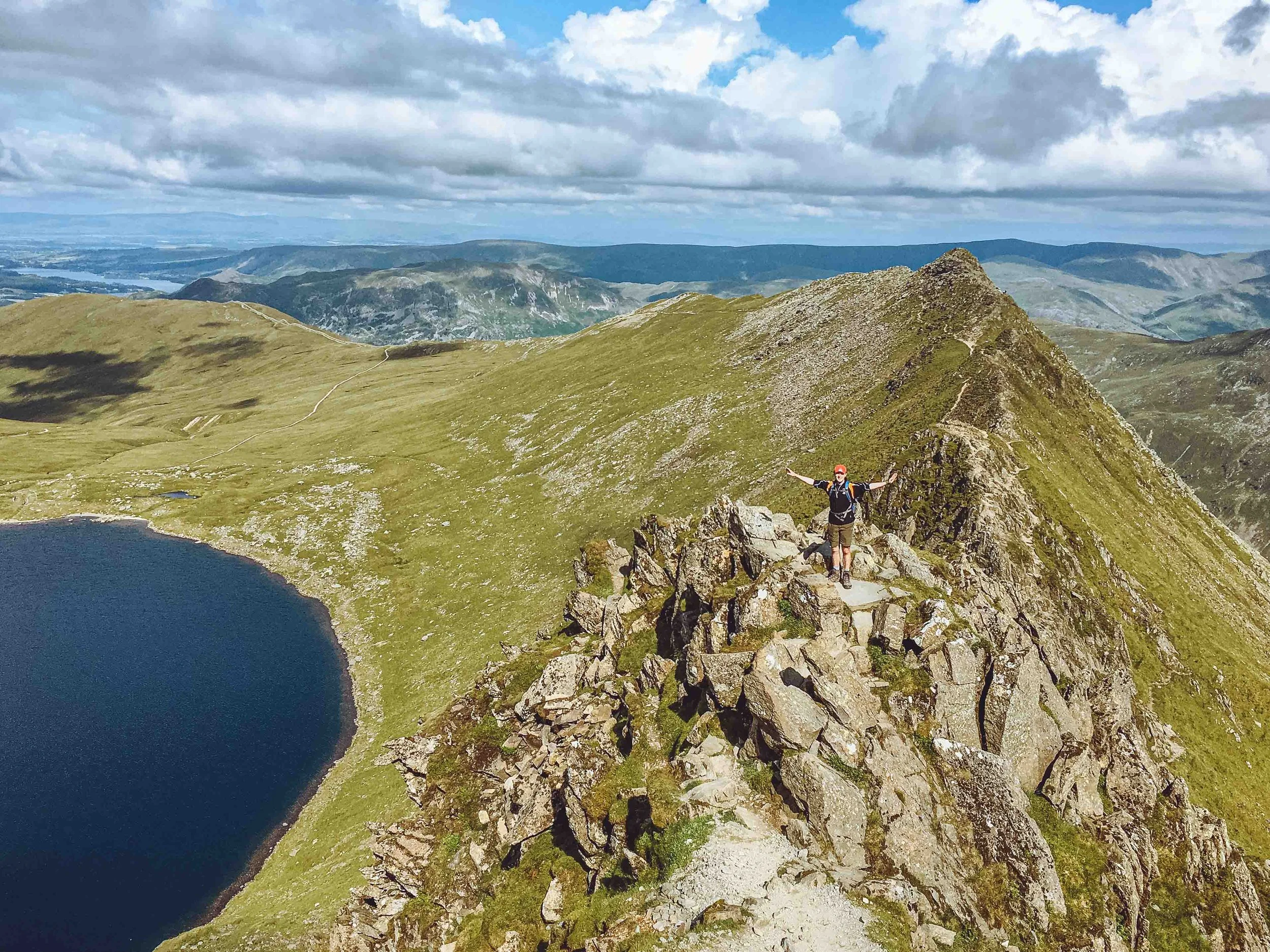 A hiker on Striding Edge ridge on Helvellyn.